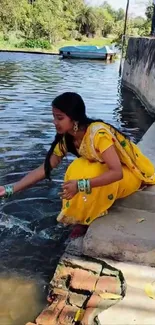 Woman in a yellow dress by a riverside, splashing water.