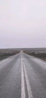 Serene endless road under a misty sky wallpaper.