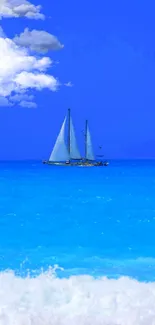 Sailboat on a vibrant blue sea with clear sky.