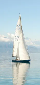 Peaceful sailboat on calm blue waters with clear skies.