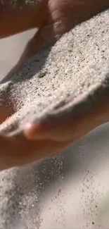 Calm wallpaper of sand flowing through hands.