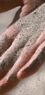 Close-up of sand flowing over a hand, capturing nature's serene beauty.