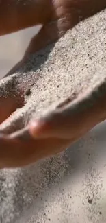 A close-up of sand gently flowing through a hand, creating a serene background.