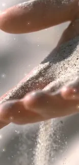 Hand with sand flowing peacefully through fingers.