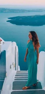 Woman in blue dress overlooking Santorini sea.