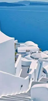 Beautiful Santorini white buildings by blue sea.