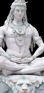 Serene white statue of Lord Shiva meditating in lotus position on a decorative base.