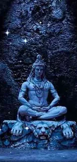 Shiva statue in blue light, meditating in a tranquil setting.