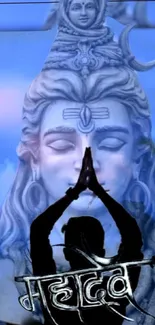 Shiva statue in meditation with blue serene background.