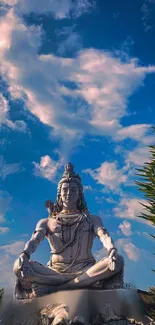 Shiva statue under a vibrant blue sky, capturing spiritual tranquility.