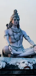 Majestic statue of Lord Shiva meditating at sunset.