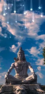 Statue of Lord Shiva under a vivid blue sky with clouds and greenery.