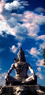 Majestic Shiva statue under a vibrant blue sky, surrounded by lush greenery.