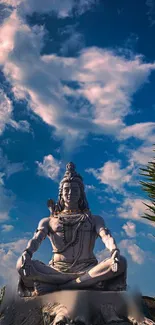 Shiva statue under blue sky, exuding tranquility and spiritual calm.