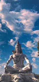 Statue of Lord Shiva under a dramatic blue sky.