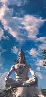 Lord Shiva statue meditating under a vibrant blue sky.