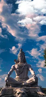 Shiva statue against a vibrant sky.