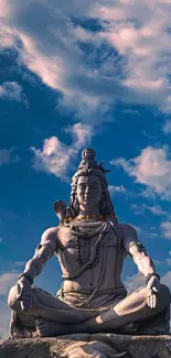 Serene Shiva statue under a blue sky.