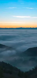 A serene sky over misty mountains wallpaper.