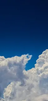 Vivid blue sky with fluffy white clouds forming a serene mobile wallpaper.