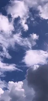 Beautiful blue sky with fluffy white clouds and a shining sun.