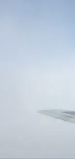 Mobile wallpaper of a plane wing under a vast light blue sky.