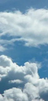 Serene sky with fluffy white clouds against blue background.