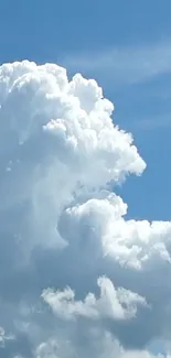 Fluffy clouds against a bright blue sky.