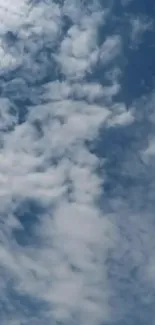 Serene sky with fluffy white clouds and a blue backdrop.