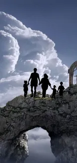 Family silhouette on rocky arch under cloudy sky.