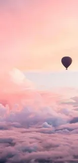 Hot air balloon above pastel clouds and pink sky.