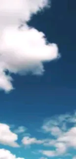 Fluffy white clouds in a vibrant blue sky.