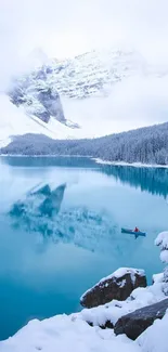 Snowy lake and mountains with a small boat.