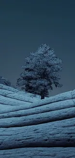 A serene snowy landscape with a lone tree under a twilight sky.