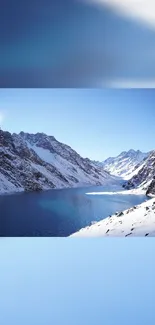 Snowy mountains and clear lake under a blue sky mobile wallpaper.