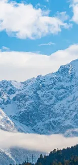 Serene snowy mountain peaks under a clear blue sky with fluffy clouds.