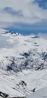 A serene snowy mountain landscape under a clear blue sky.