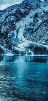 Snowy mountain with turquoise lake reflection wallpaper.