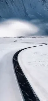 A winding road through a snowy mountain landscape.