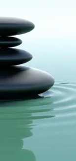 Serene mobile wallpaper with stacked stones on calm water.