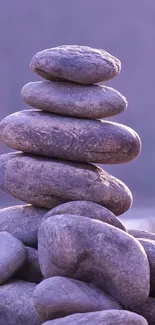 Purple stacked stones on a calming background wallpaper.