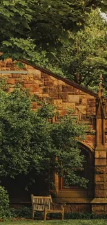 Rustic stone building with green trees and a wooden bench.