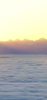 Beautiful sunrise over misty mountains creating a serene mobile wallpaper.
