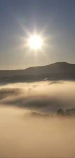 Serene sunrise over misty hills with glowing sun and tranquil view.