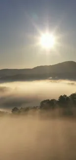 Sunrise over misty mountains with golden rays creating a serene scene.