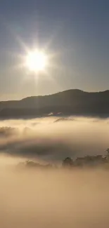 Sunrise over misty mountains with fog and bright sun.