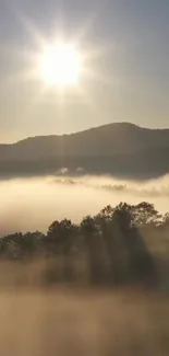 Serene sunrise over misty mountains with soft, glowing sunlight.