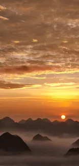 Golden sunrise over mountains with clouds and a serene atmosphere.