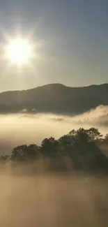 Sunrise over misty mountains with a bright sky and soft light.