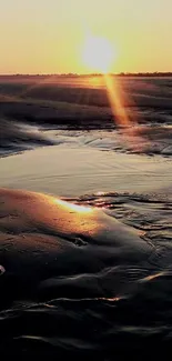 Serene sunset on a tranquil beach with glowing reflections.